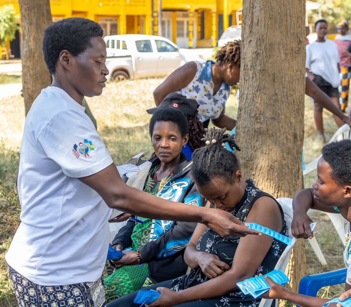 A peer educator distributing prevention supplies at a community session